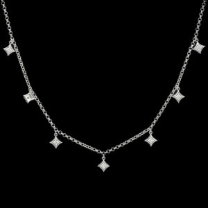 a silver necklace with five diamonds on it