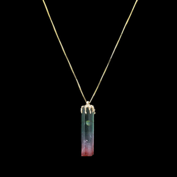 a necklace with a pendant that has a small rectangular piece of glass on it