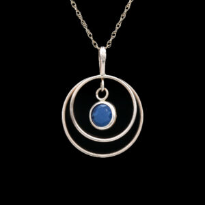 a silver necklace with a blue stone in the center
