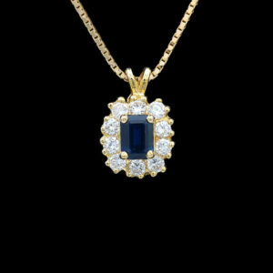 a necklace with a blue stone surrounded by white diamonds