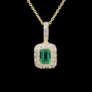 an emerald and diamond pendant on a gold chain