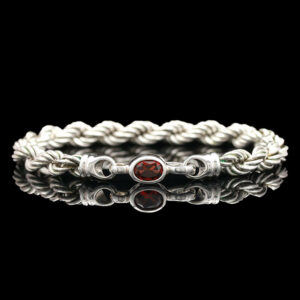 a white braid bracelet with two red stones