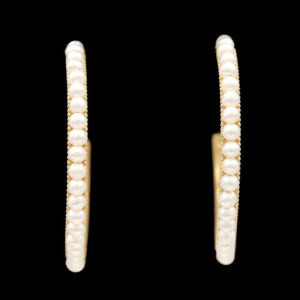 a pair of pearl hoop earrings