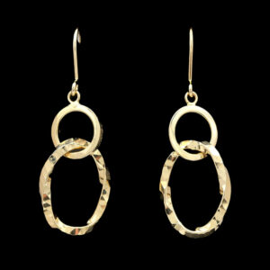 two gold circles are hanging from a pair of earrings