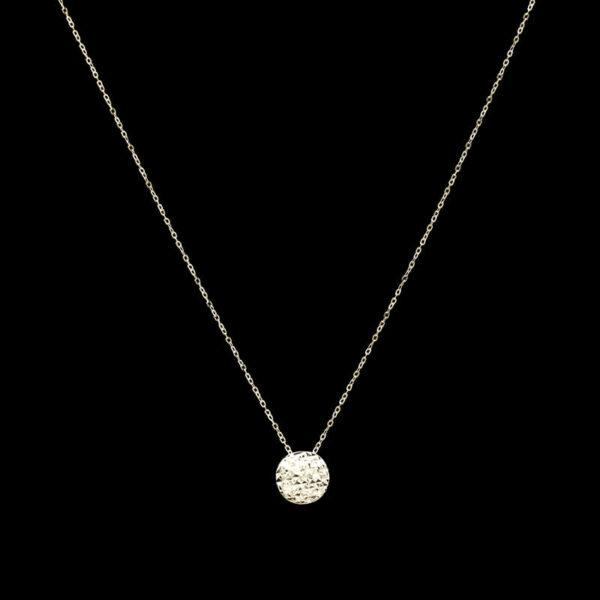 a gold necklace with a small white disc on it