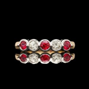 three stone ring with red and white diamonds
