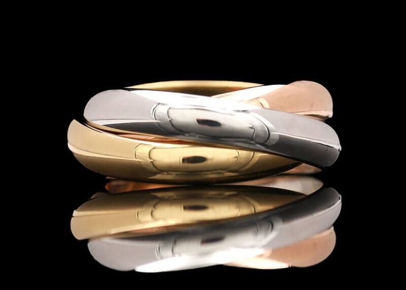 A vintage tri-color ring from Cartier with three separate bands in white, yellow, and rose gold.